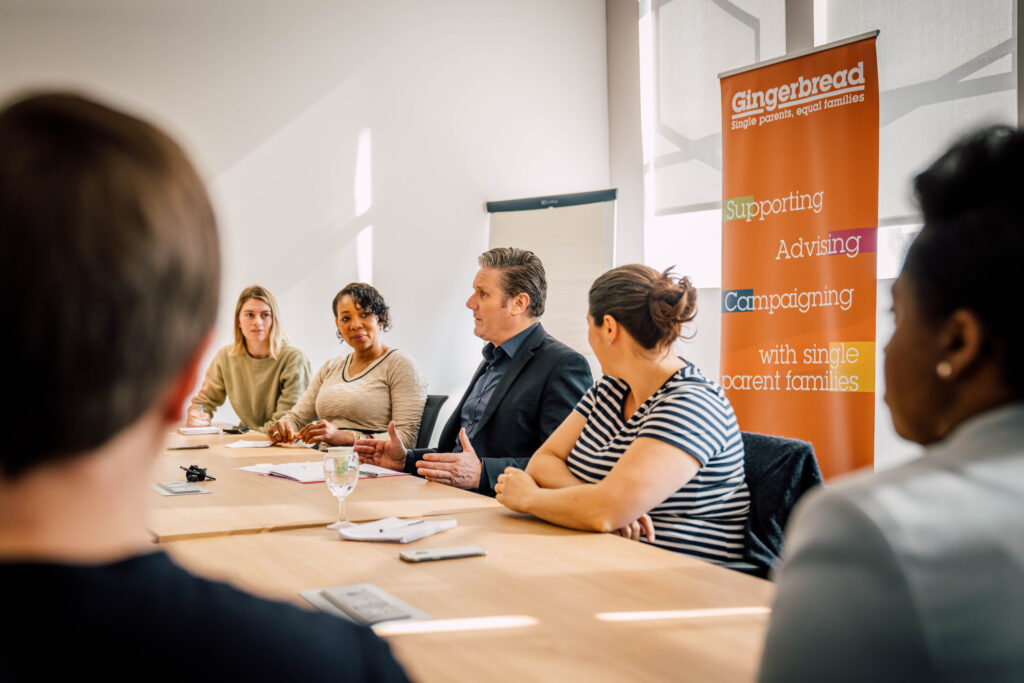 Keir Starmer sat at a boardroom table with five other people in view