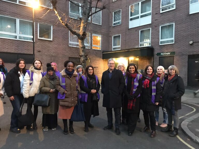 Keir Starmer with Cllr Nadia Shah and representatives from the Council, local Police and community groups outside a block of flats